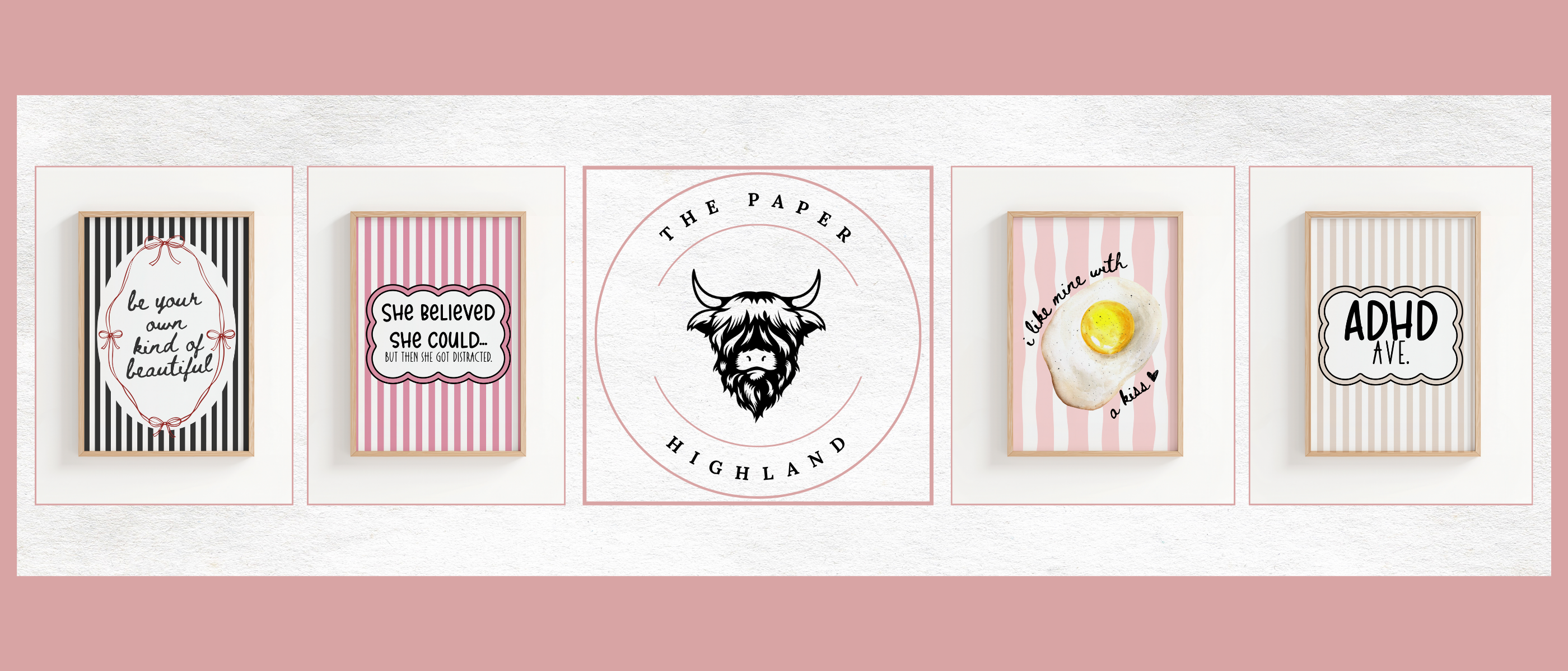 Five framed prints with various designs on a white wall with a pink border.
